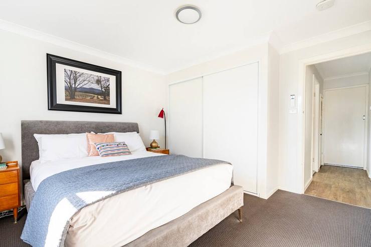 Bedroom 3 styled with velvet headboard and warm bedside lighting