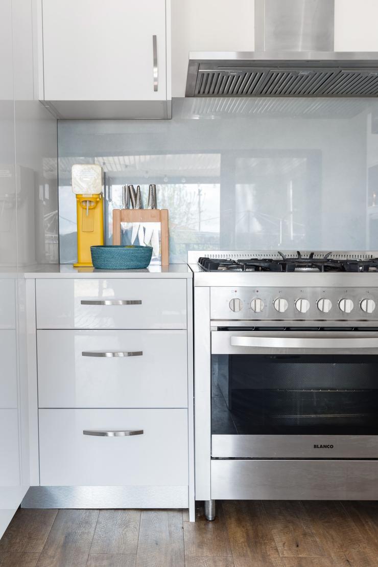 Kitchen cabinetry stocked with crockery and cookware for guests