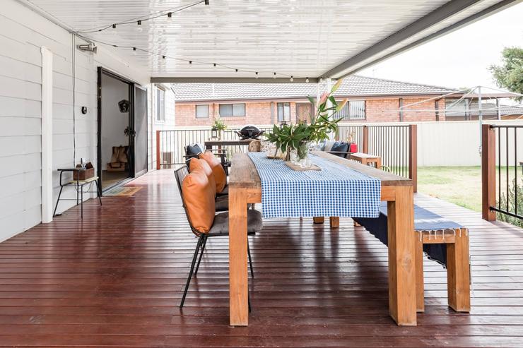Outdoor heater and lounge chairs on the covered deck at Flamingo House