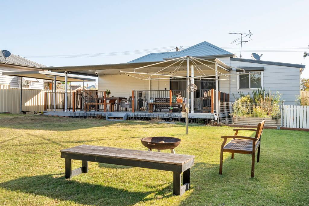 Covered outdoor deck with dining setting at Flamingo House