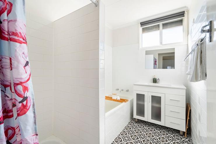 Bathroom at Flamingo House with bathtub and separate shower