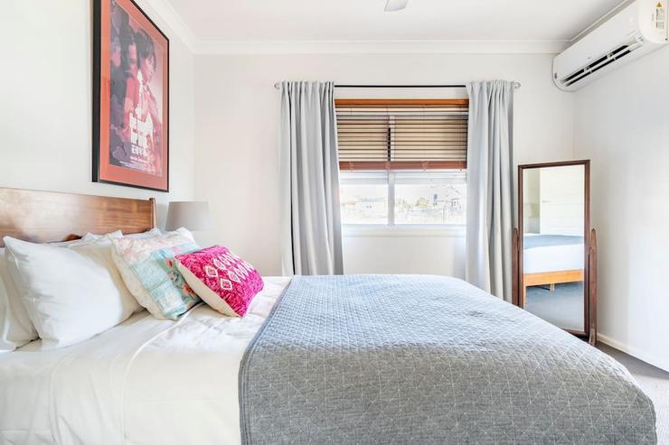 Mid century styled bedroom 1 with queen bed and hotel grade linen at Flamingo House